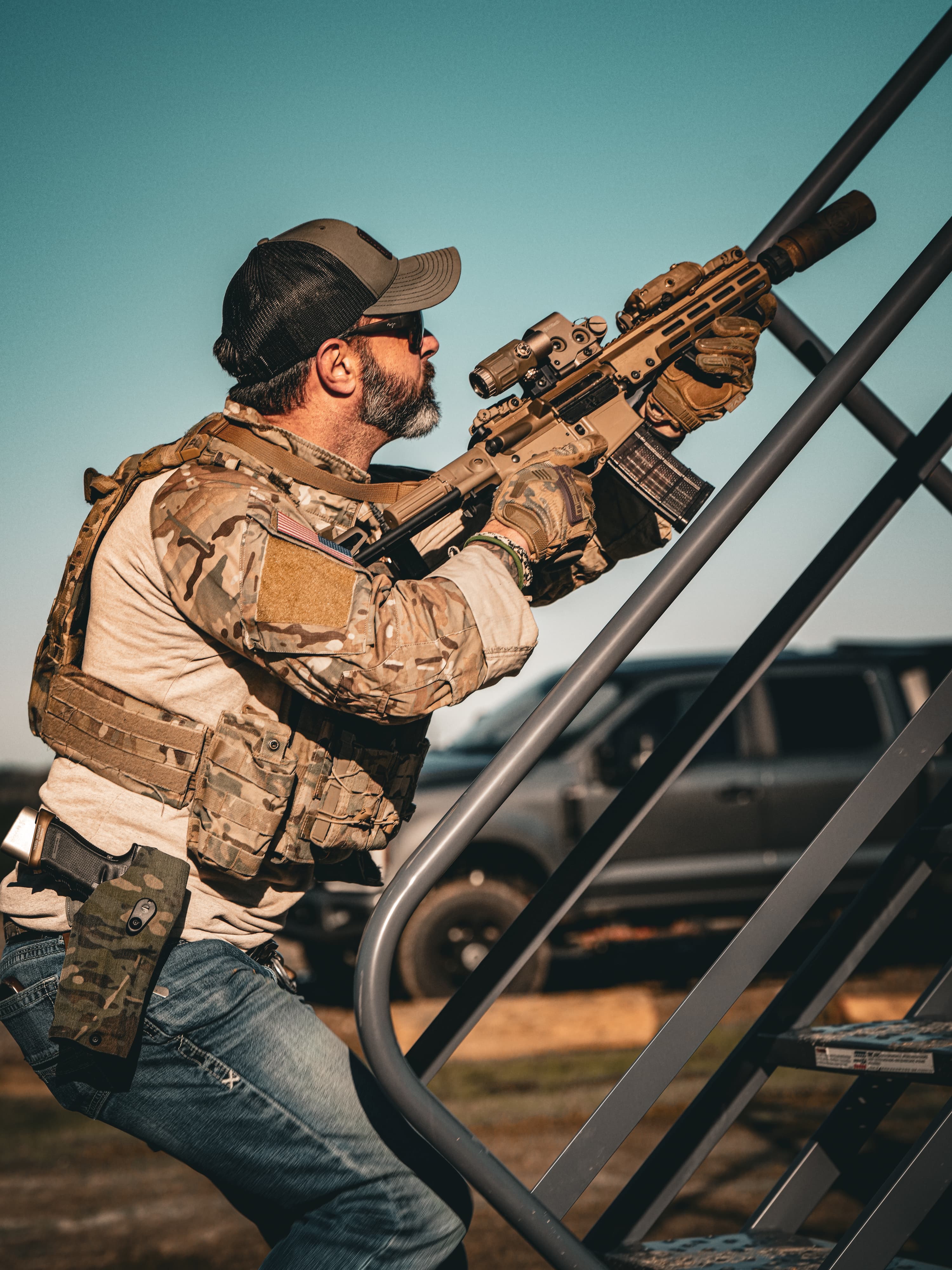 Paul shouldering the M4 with the EOTECH holographic sight and 3× magnifier mounted